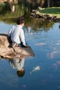 Boy looking at carp fishes Royalty Free Stock Photo