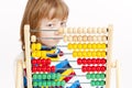 Boy Looking at Colorful Wooden Abacus Thinking