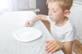 Boy is looking at an empty plate Royalty Free Stock Photo