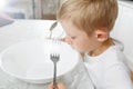 Boy is looking at an empty plate Royalty Free Stock Photo