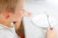 Boy is looking at an empty plate Royalty Free Stock Photo