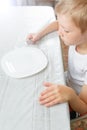 Boy is looking at an empty plate Royalty Free Stock Photo