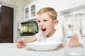 Boy is looking at an empty plate Royalty Free Stock Photo