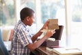 Boy Looking At Letter In Keepsake Box On Desk