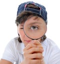 Boy looking through a magnifying glass Royalty Free Stock Photo