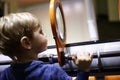 Boy looking through magnifying glass system