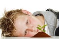 Boy looking at plant in soil