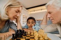 Boy looking surprised at the board while spending time with his family Royalty Free Stock Photo