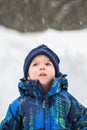 Boy Looking Up in Wonder at Snow Falling Royalty Free Stock Photo