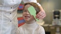 Boy looking at vision test with one eye covered with occluder Royalty Free Stock Photo