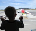 Boy looking through a window at the airport Royalty Free Stock Photo