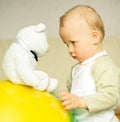 Boy looks at bear toy Royalty Free Stock Photo