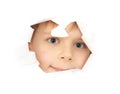 The boy looks through a hole in the paper. Isolated on a white background Royalty Free Stock Photo