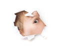 The boy looks through a hole in the paper. Isolated on a white background Royalty Free Stock Photo