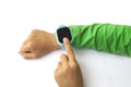 boy looks at information on digital clock pressing screen with his index finger. Modern childrens technologies. GPS tracker for Royalty Free Stock Photo