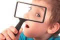 Boy looks through magnifier Royalty Free Stock Photo