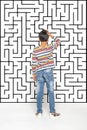 A boy looks at the maze depicted on the wall and makes a choice or makes a decision. Education concept, growing up