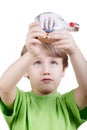 Boy looks at miniature model of tallship in bottle