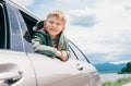 Boy looks out from car window Royalty Free Stock Photo