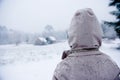 Boy looks out over a wintry landscape Royalty Free Stock Photo