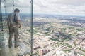 A boy looks out from the transparent balcony of th willis tower Royalty Free Stock Photo