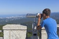 Boy looks at the resort city of Sochi through binoculars from a tower on the mountain Big Ahun Royalty Free Stock Photo