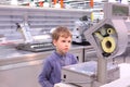Boy looks at scales in empty shop