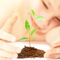 Boy looks at a young plant Royalty Free Stock Photo