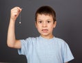 Boy with lost tooth on thread Royalty Free Stock Photo