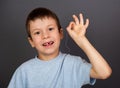 Boy with lost tooth on thread