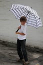 Rascal with many freckles under piano  umbrella Royalty Free Stock Photo