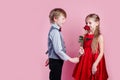 Boy in love giving cute girl red rose , Valentines day surprise Royalty Free Stock Photo