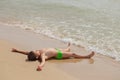 Boy lying on the beach and sunning Royalty Free Stock Photo