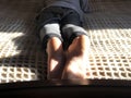 Boy lying on bed close-up. Boy`s feet close-up. Toes