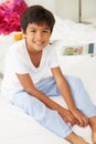 Boy Lying On Bed In Pajamas Royalty Free Stock Photo