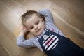 Boy lying on floor with hands behind his head Royalty Free Stock Photo