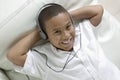 Boy lying on sofa Listening to Music Royalty Free Stock Photo