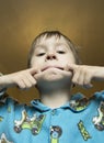 Boy make grimace on his face. Boy ape and make strange face. Boy Royalty Free Stock Photo