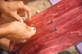 Boy makes bolt holes on the griptape on a skateboard Royalty Free Stock Photo