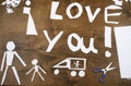 Boy makes origami - car and family, children, parent, I love you text, top view on wood background Royalty Free Stock Photo