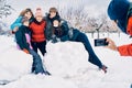 Boy makes a photo with the mobile of his family, five very happy and smiling Caucasian girls in the snow