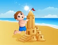 Boy making a big sand castle at the beach Royalty Free Stock Photo