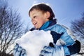 Boy is making a big snowball in the mountains, winter fun Royalty Free Stock Photo