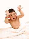 Boy making faces on bed Royalty Free Stock Photo