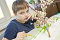 Boy making flowering apple tree garden layout. Royalty Free Stock Photo