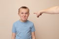 Boy making funny faces while getting pointed at