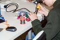 A boy making a robot with the electric soldering iron