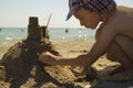 Boy making sand castle at beach Royalty Free Stock Photo