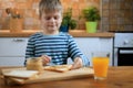 Boy making a sandwich with peanut butter on the kitchen Royalty Free Stock Photo