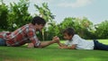 Boy and man armwrestling on grass. Father and son practising arm wrestling Royalty Free Stock Photo